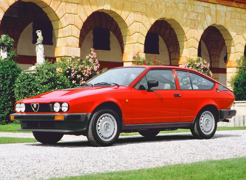 Alfa Romeo GTV6 in classic red showing the distinctive wedge-shaped coupe design