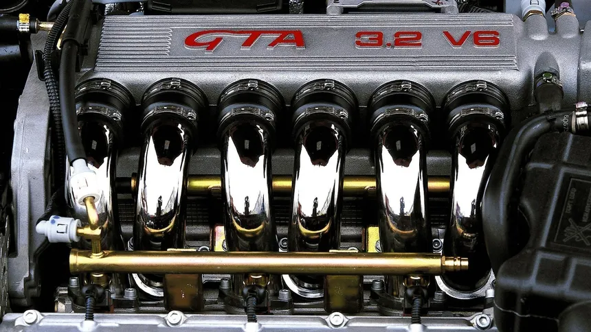 Alfa Romeo Busso V6 engine on stand showing aluminum block and quad cam covers