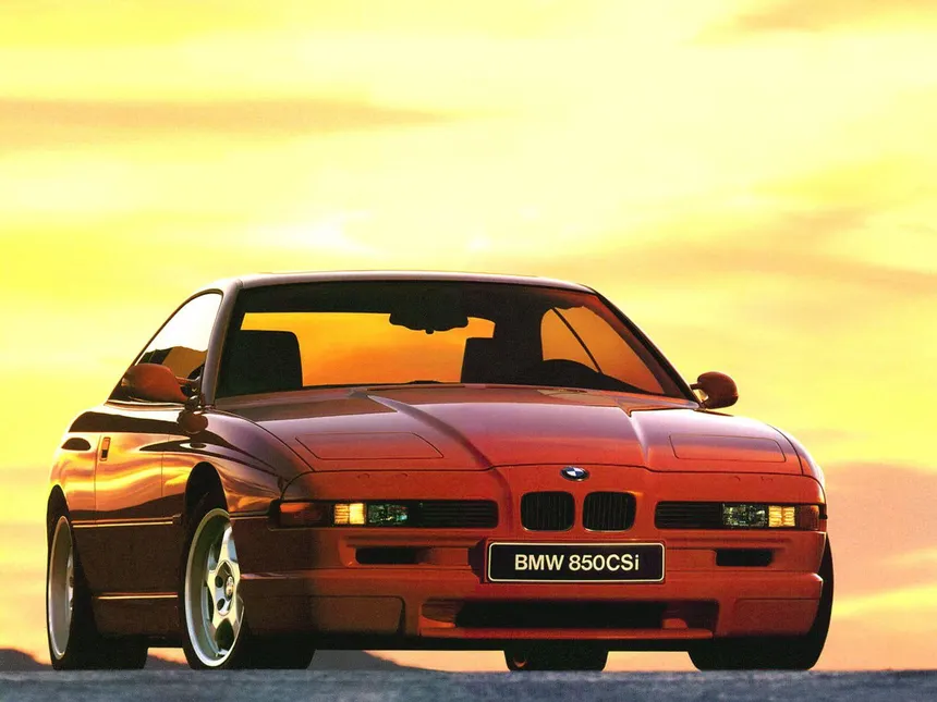 Red BMW 850 CSi with closed pop-up headlights seen from front three-quarter angle