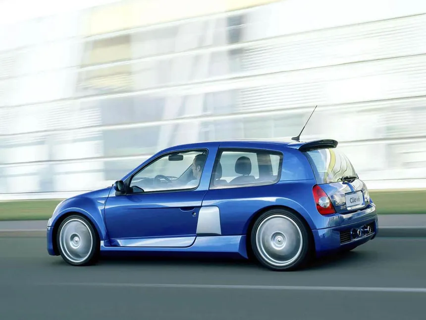 Blue Renault Clio V6 Phase 2 with widened bodywork and lateral air intakes, mid-mounted V6 engine visible