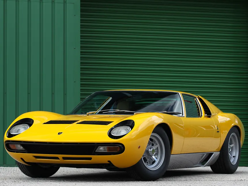 Lamborghini Miura P400 SV in orange with transverse V12 engine visible through rear louvers