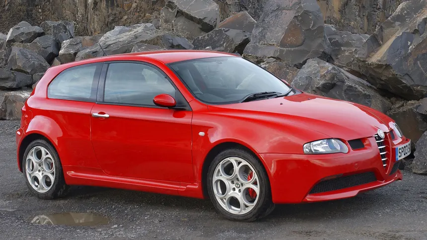 Red Alfa Romeo 147 GTA front three-quarter view showing widened bodywork and 17-inch alloy wheels
