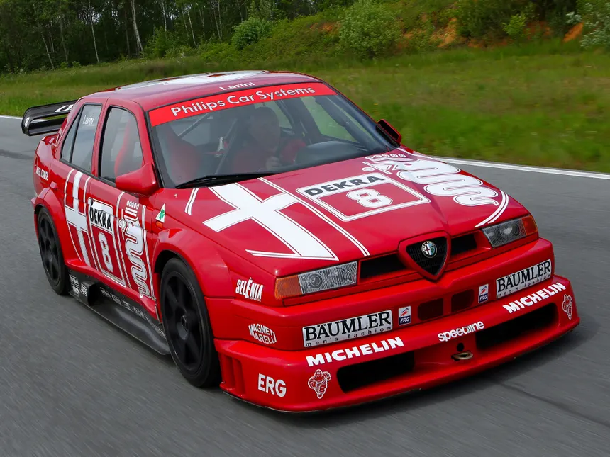 Red Alfa Romeo 155 V6 TI DTM 1993 race car with competition numbers and widened bodywork on track during Deutsche Tourenwagen Meisterschaft race