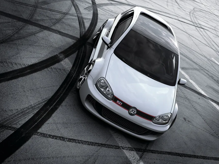 VW Golf GTI W12-650 concept in white livery with widened body and carbon fiber roof, front three-quarter view