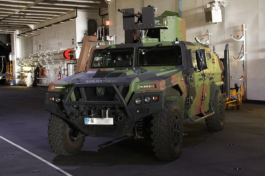 Spanish Army URO VAMTAC ST5 armoured tactical vehicle moving across rough terrain, fitted with Alakran 120 mm mortar carrier configuration and STANAG 4569 Level 3 structural armour.