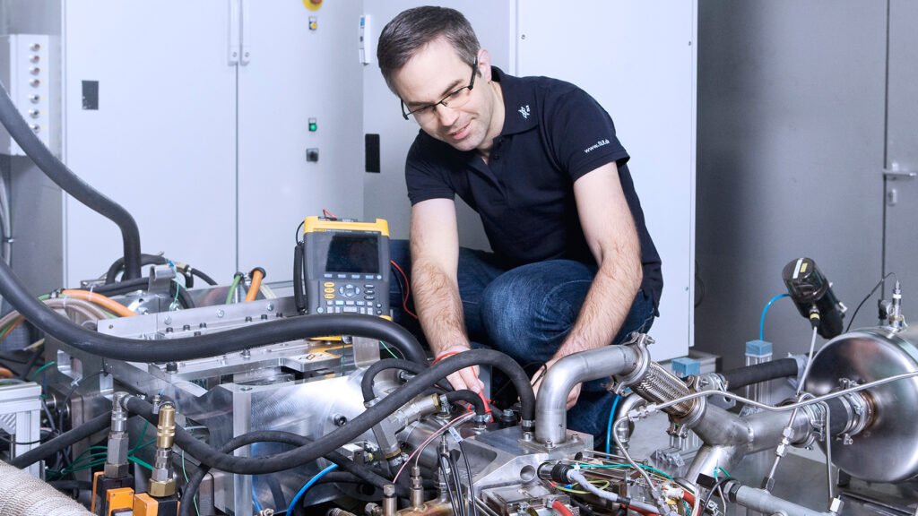 DLR engineer working on a free-piston linear generator range extender in 2013