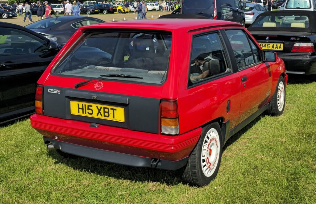 Rear of a red Opel Corsa GSi with the black panel between the taillights and the hatch spoiler