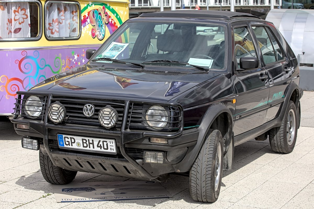 Black Volkswagen Golf Country with its bull bar and auxiliary driving lights