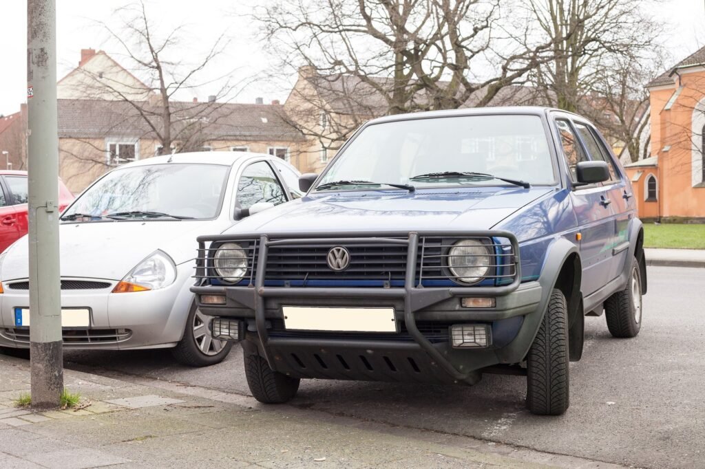 Volkswagen Golf Country blu parcheggiata in strada, con l'assetto rialzato