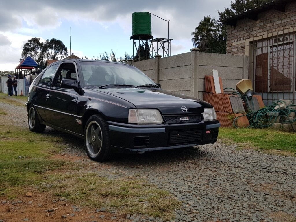Red Top engine with its red cover in the engine bay of a South African Opel Kadett Superboss
