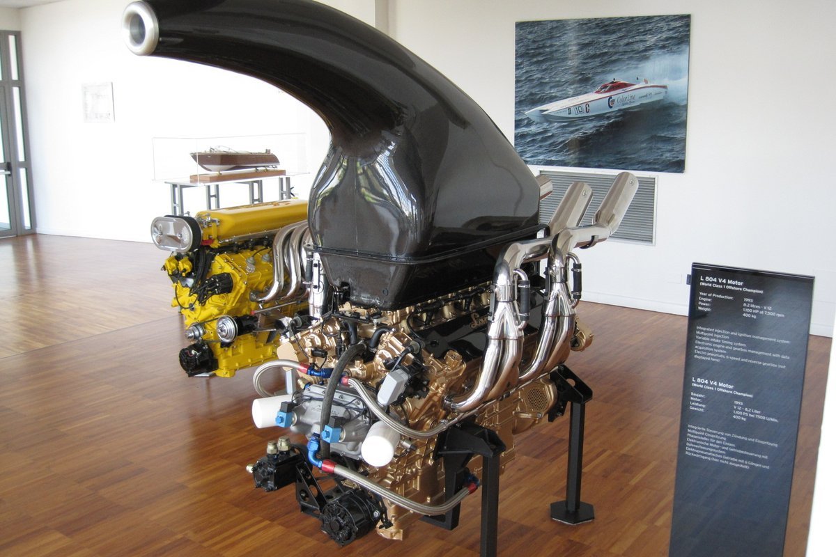 Lamborghini L804 and L900 marine engines on display in Sant'Agata, with a model of Ferruccio's Riva Aquarama behind them
