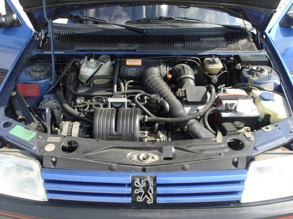 Engine bay of a 1993 Peugeot 205 GTI 1.9 with the XU9J four-cylinder