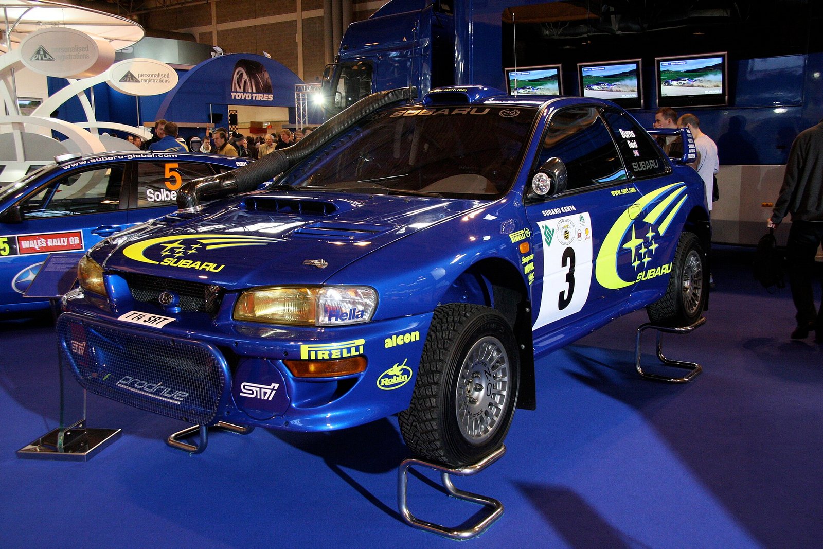 Subaru Impreza WRC azul con la decoración 555 expuesto en un stand