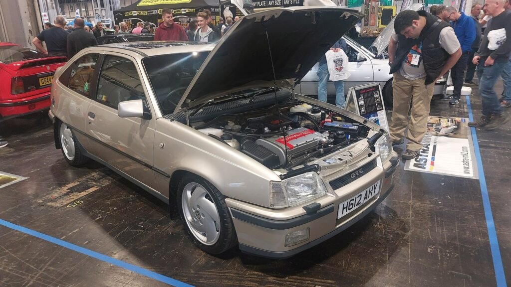 Silver 1990 Vauxhall Astra GTE 16V with its hood open at a car show